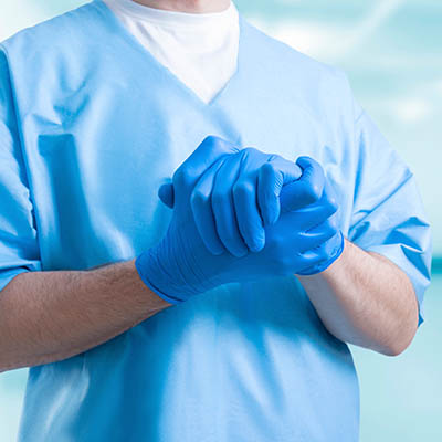 Surgeon with blue gloves on
